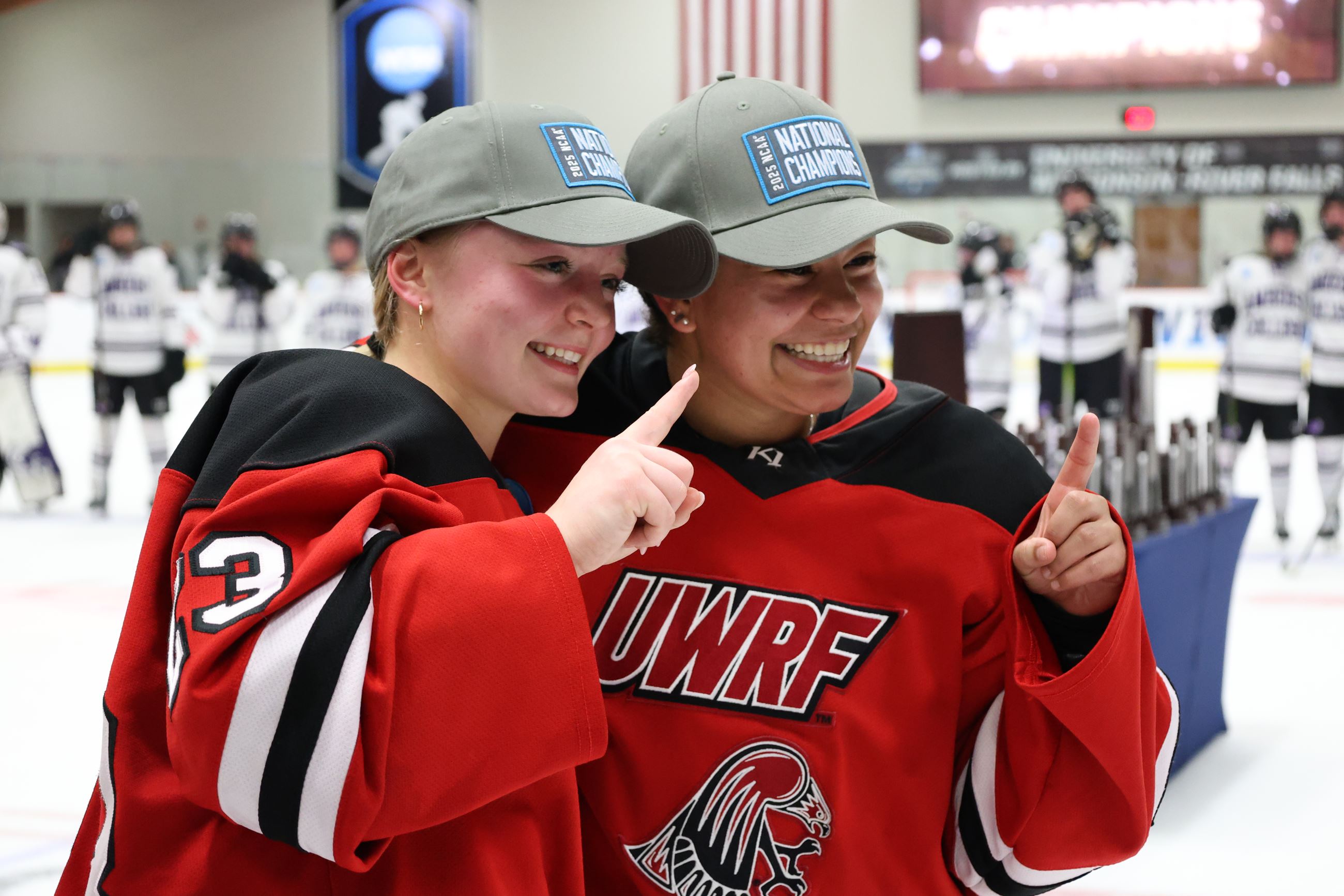 Two women from UWRF hockey team celebrating championship