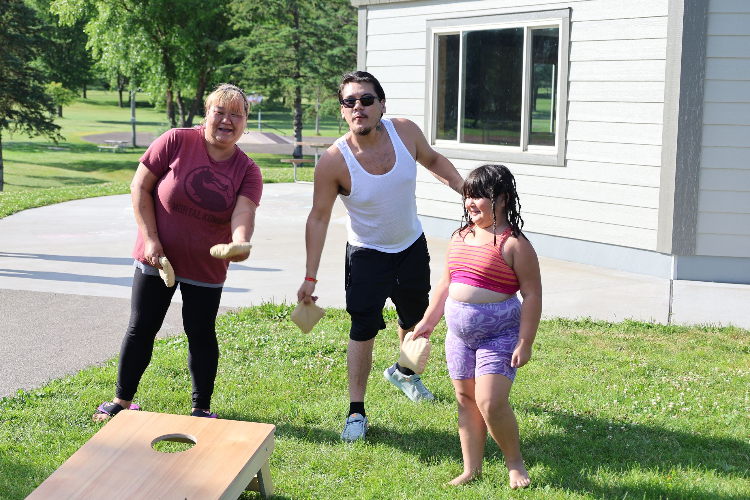A family playing bag toss outdoors